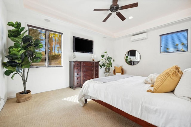 bedroom featuring light carpet, a raised ceiling, an AC wall unit, and ceiling fan