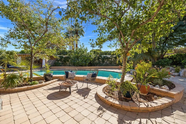 view of swimming pool with an outdoor fire pit