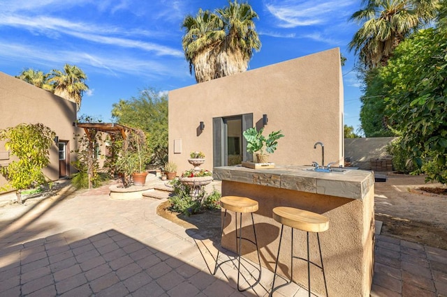 view of patio / terrace with an outdoor wet bar