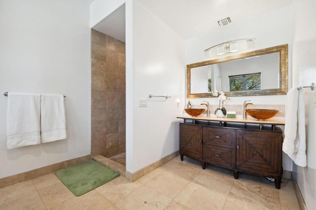 bathroom with vanity and a shower