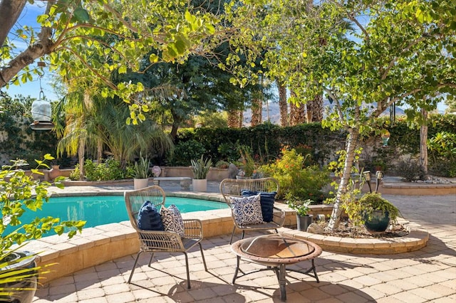 view of pool featuring an outdoor fire pit