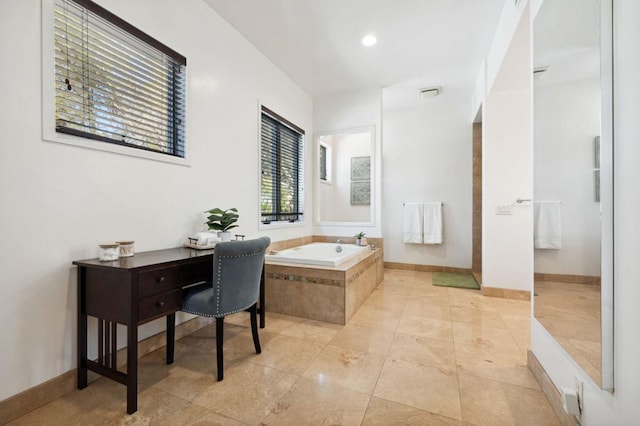 bathroom featuring tiled tub and tile patterned floors