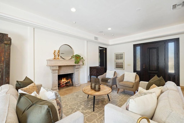 living room featuring a high end fireplace