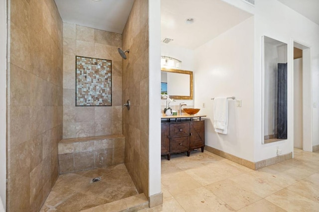 bathroom featuring vanity and tiled shower