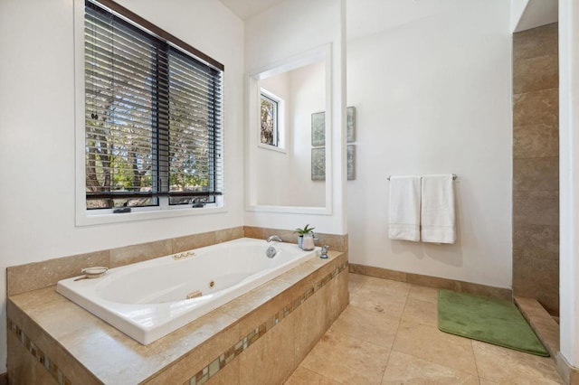 bathroom featuring tile patterned floors and tiled tub