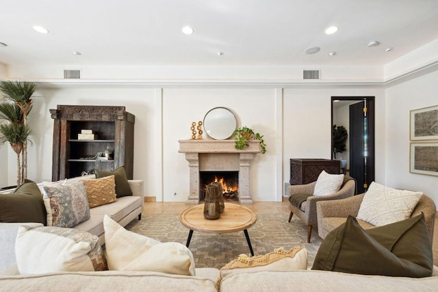 tiled living room featuring a premium fireplace