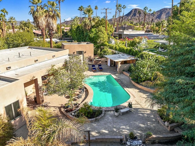 view of swimming pool featuring a mountain view and a patio area