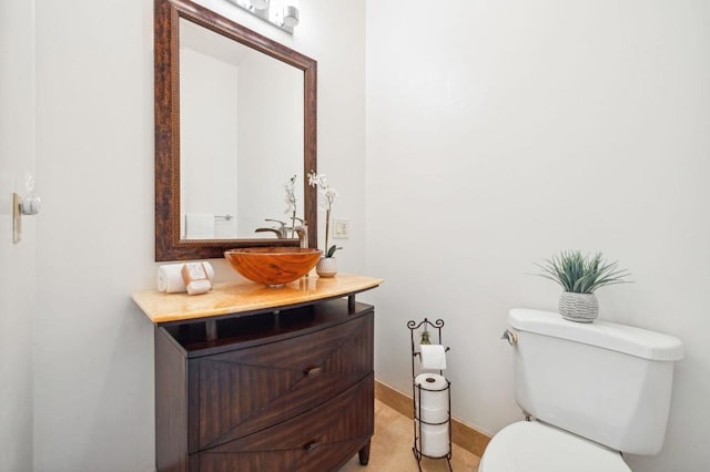 bathroom featuring vanity, tile patterned floors, and toilet