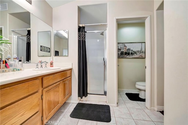 bathroom featuring a shower, tile patterned flooring, vanity, and toilet