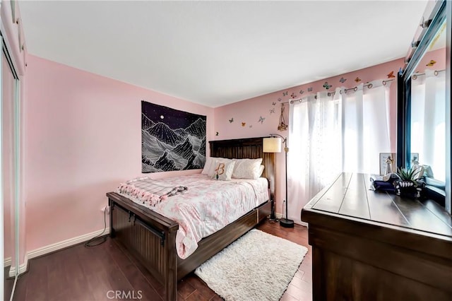 bedroom with dark wood-type flooring