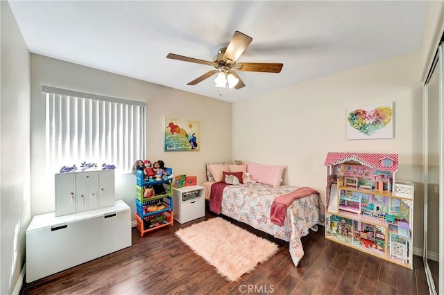 bedroom featuring dark hardwood / wood-style flooring, a closet, and ceiling fan