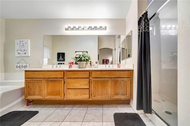 bathroom featuring tile patterned floors, vanity, and separate shower and tub