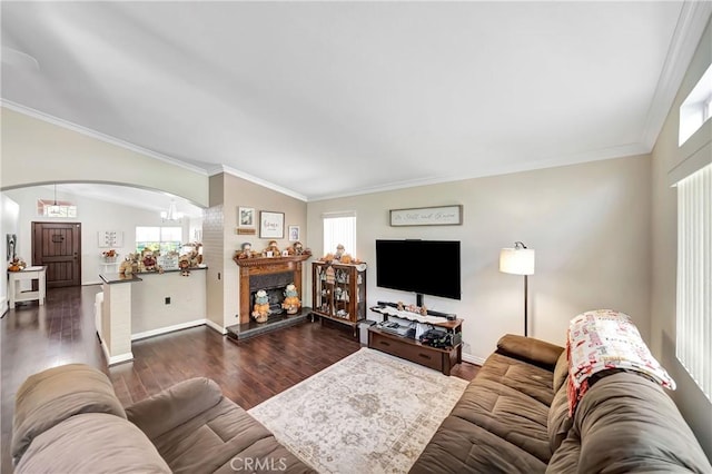 living room with dark hardwood / wood-style flooring, vaulted ceiling, and ornamental molding