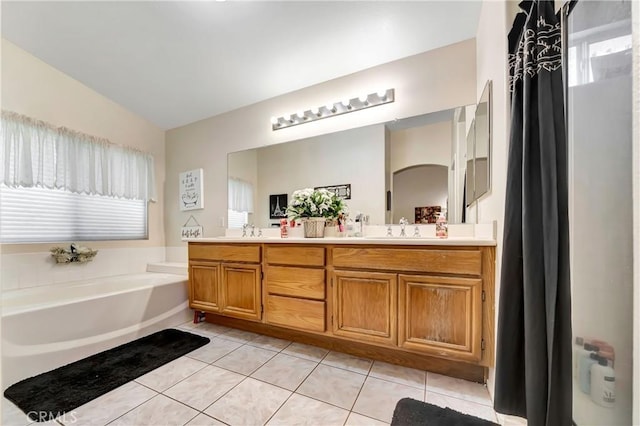 bathroom featuring tile patterned floors, a washtub, vanity, and lofted ceiling