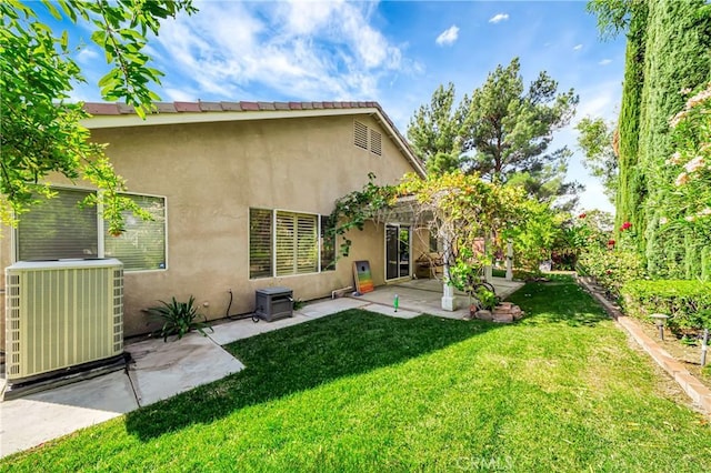 rear view of house featuring a yard, a patio, and cooling unit