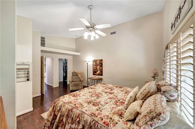 bedroom with ceiling fan, dark hardwood / wood-style flooring, a spacious closet, and high vaulted ceiling