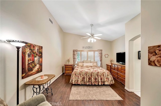 bedroom featuring dark hardwood / wood-style flooring, high vaulted ceiling, and ceiling fan