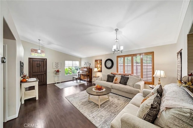 living room with dark hardwood / wood-style flooring, plenty of natural light, vaulted ceiling, and a notable chandelier