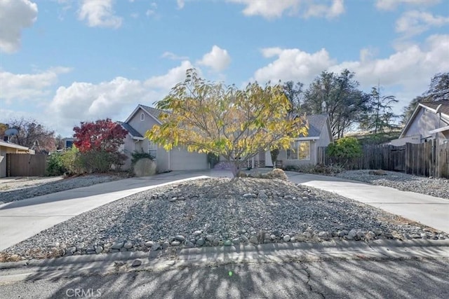 view of property hidden behind natural elements featuring a garage