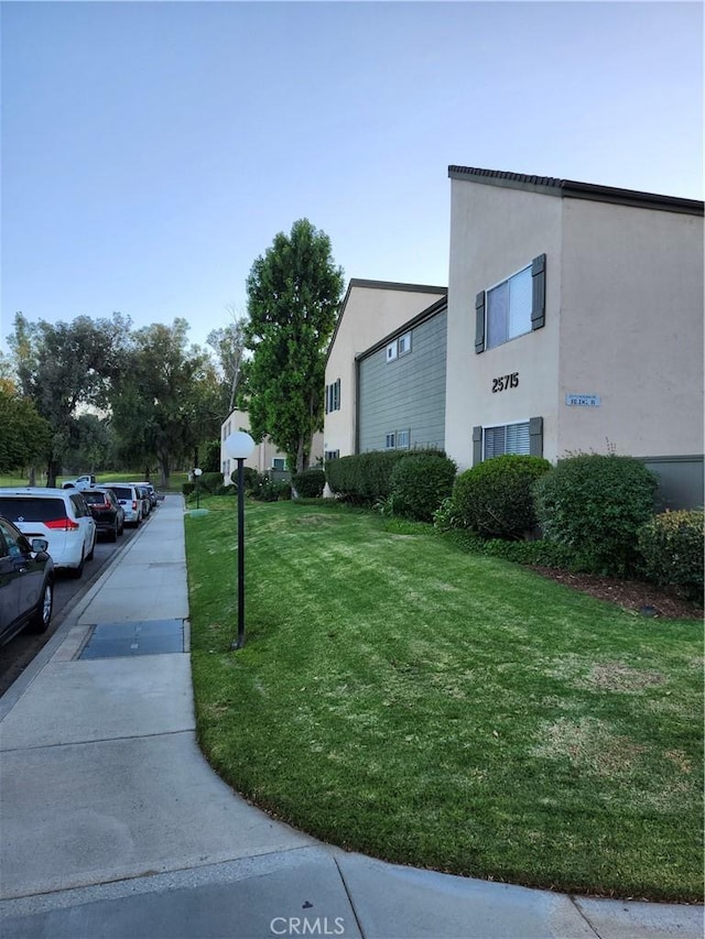 view of side of property featuring a yard