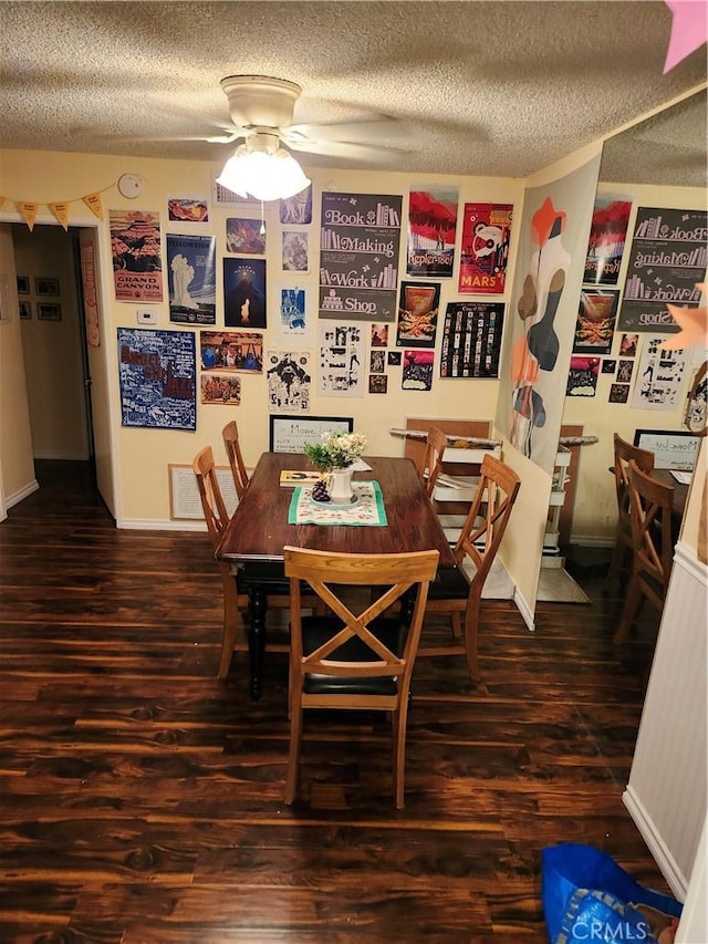 dining room with ceiling fan, dark hardwood / wood-style flooring, and a textured ceiling