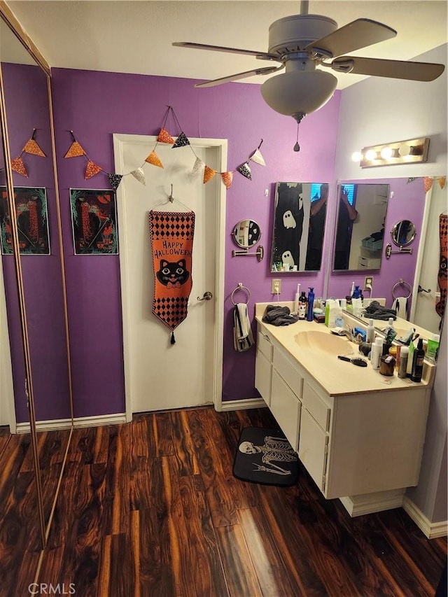 bathroom with vanity, hardwood / wood-style flooring, and ceiling fan