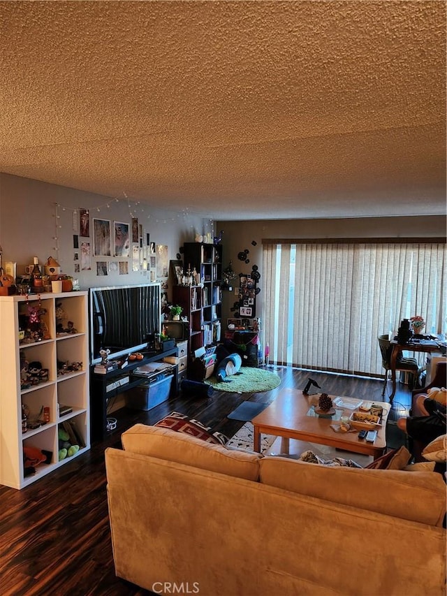 living room with wood-type flooring and a textured ceiling