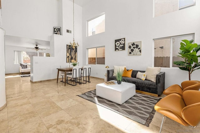 living room featuring a high ceiling and ceiling fan