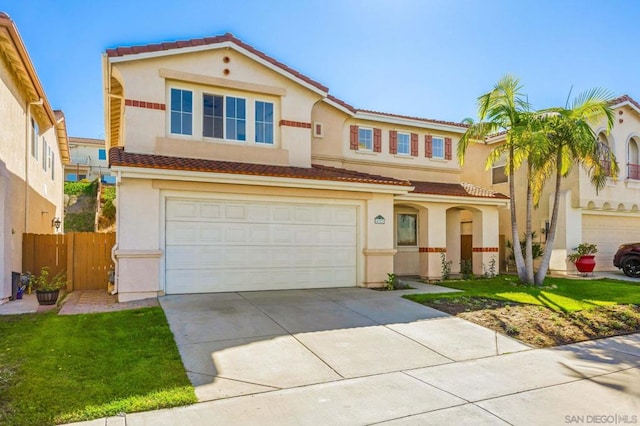 mediterranean / spanish-style home with a garage and a front lawn