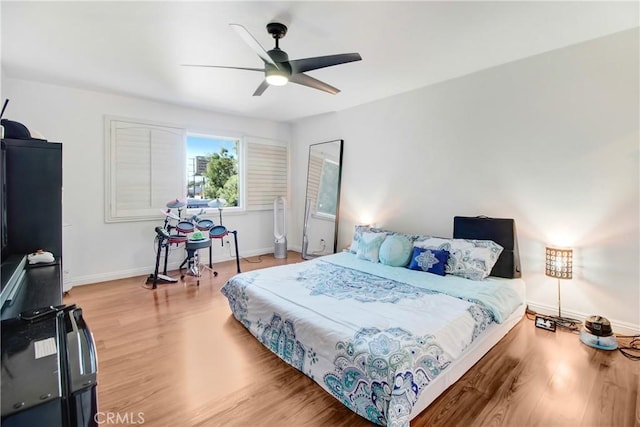 bedroom with hardwood / wood-style flooring and ceiling fan