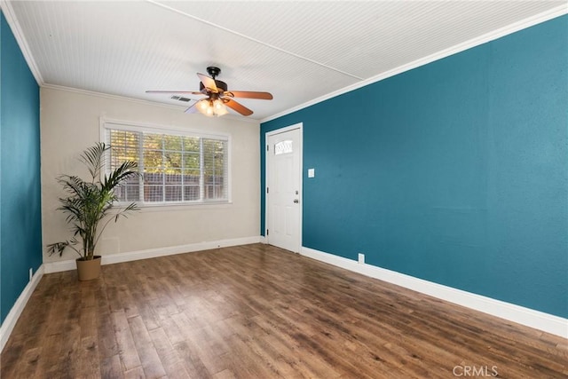 unfurnished room with crown molding, ceiling fan, and dark wood-type flooring