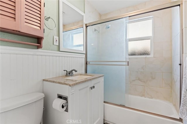 full bathroom featuring vanity, toilet, and enclosed tub / shower combo