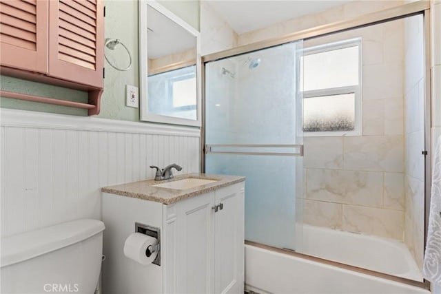 553 E 23rd St, Chico, CA 95928 - bathroom with wainscoting, bath / shower combo with glass door, and vanity