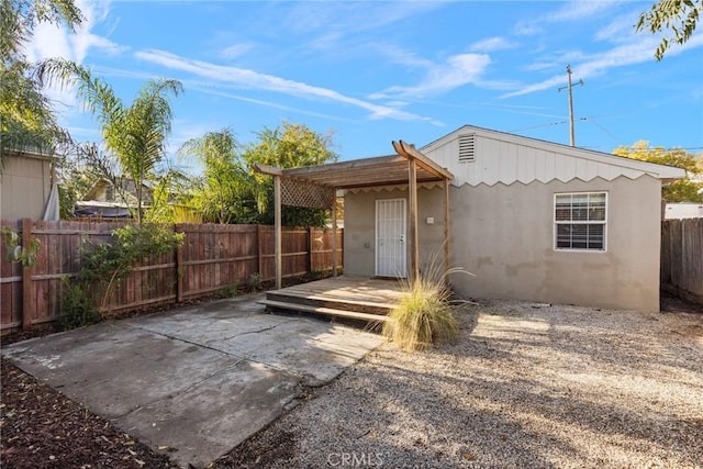 553 E 23rd St, Chico, CA 95928 - rear view of house featuring stucco siding, a fenced backyard, a patio area, and a wooden deck