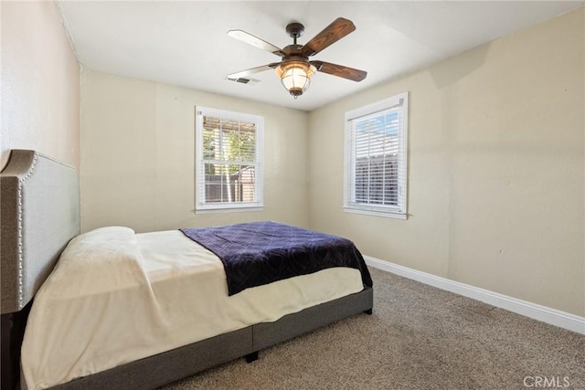 bedroom with carpet, multiple windows, and ceiling fan