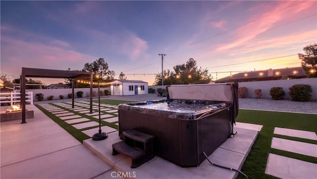 patio terrace at dusk with an outdoor structure and a hot tub