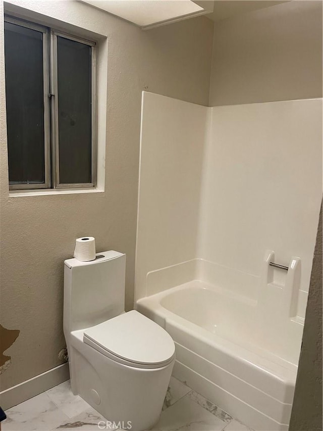 bathroom featuring bathing tub / shower combination and toilet