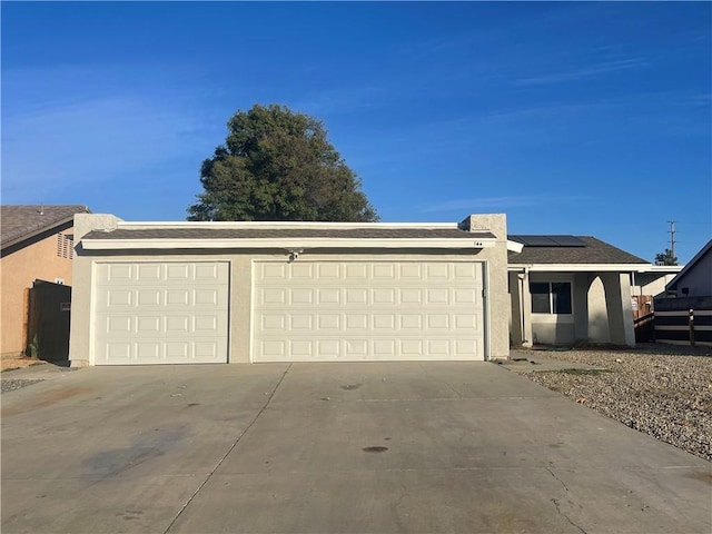 view of front of property with a garage and solar panels