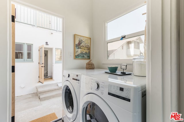 clothes washing area featuring washer and dryer