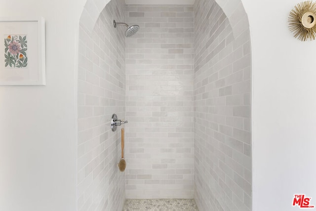 bathroom with tiled shower