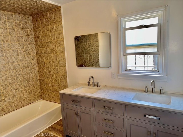 bathroom featuring vanity, wood-type flooring, and tiled shower / bath