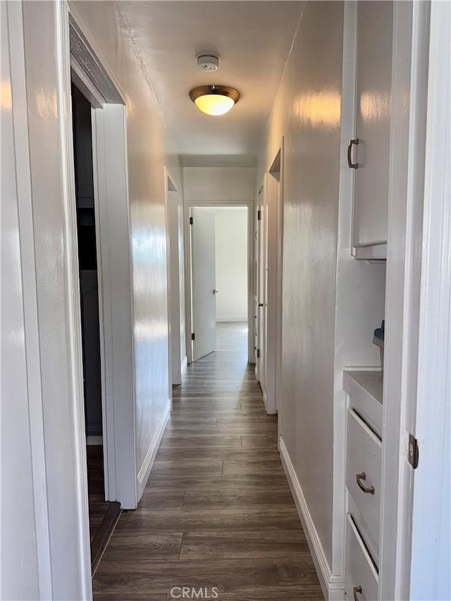 corridor featuring dark wood-type flooring