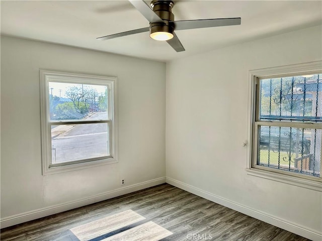 spare room featuring ceiling fan, a healthy amount of sunlight, and light hardwood / wood-style floors