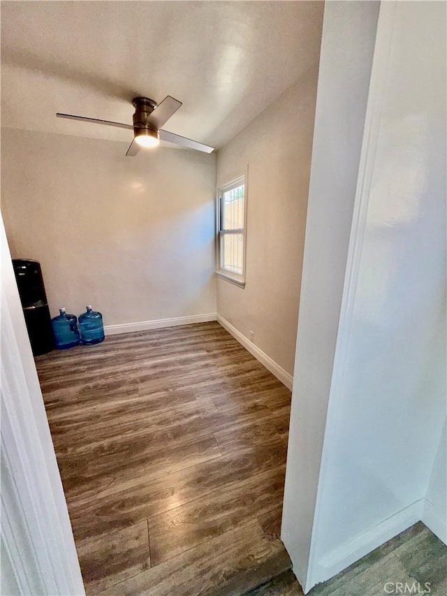 spare room featuring ceiling fan and dark hardwood / wood-style flooring