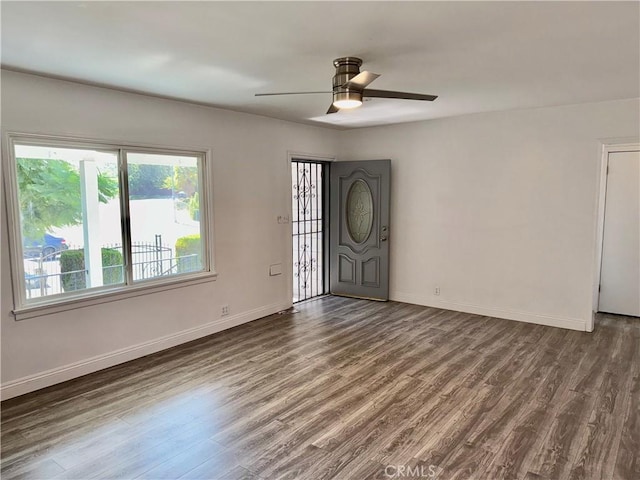 interior space featuring ceiling fan and dark hardwood / wood-style floors