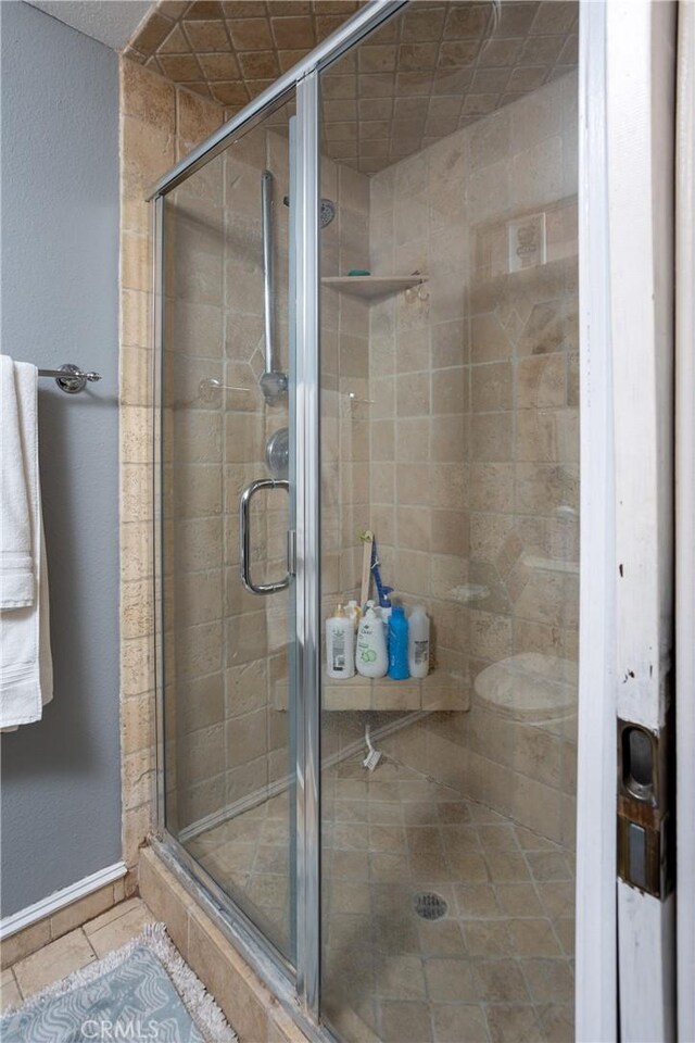 bathroom featuring tile patterned floors and an enclosed shower