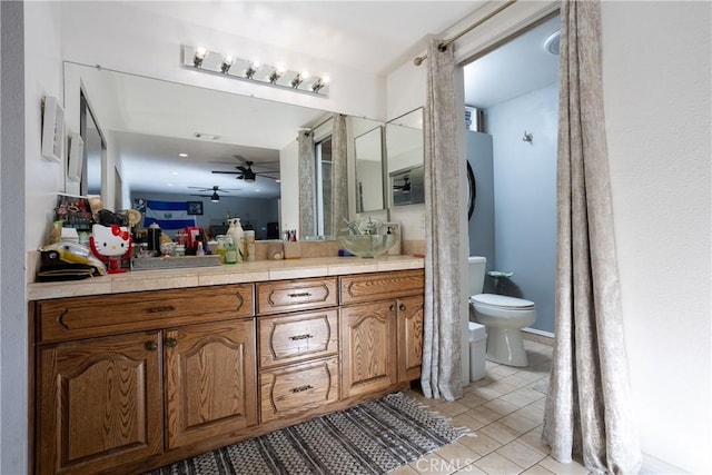 bathroom featuring tile patterned flooring, vanity, and toilet