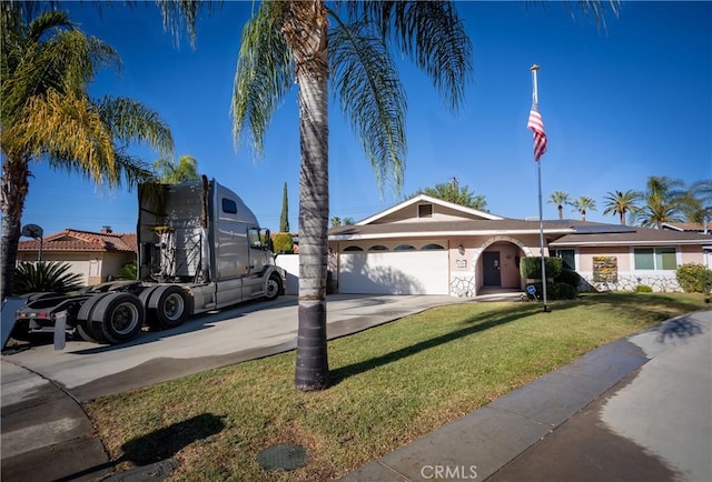 view of front of house featuring a garage and a front lawn