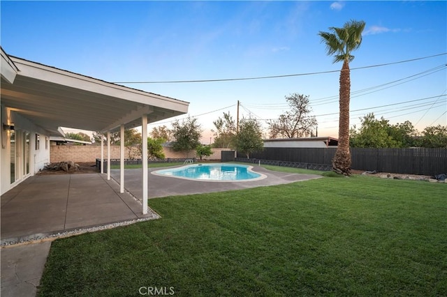 view of yard with a fenced in pool and a patio area