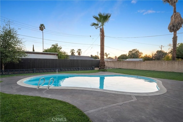 view of pool featuring a patio area and a lawn